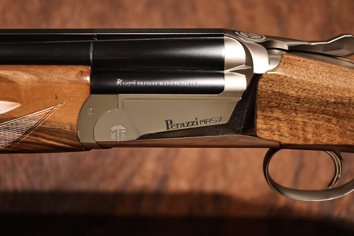 close up of left handed Perazzi MR57, side view with engraved Perazzi MR57, for sale at Berg's Outdoors